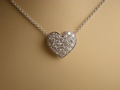 "This pave diamond heart pendent is 11.6 mm long and 12.6 mm wide. The 26 diamonds clarity is VS and G-H color and the total weight is .51 cts. Pendent and chain are 18k white gold total weight is approximately 3.2 grams. The 18k white gold chain is made in Italy and can be 16, 17 or 18 inch long. We love these pendent because it represents the way jewelry should be made with craftsmanship and quality. This pendent is anything but ordinary. Our pieces are designed and made with craftsmanship and Gold Platinum Necklace Gift, Hallmarked Platinum Diamond Necklace As Gift, Luxury Platinum Jewelry For Valentine's Day, Gold Diamond Necklace In Platinum For Anniversary, Gold Platinum Diamond Necklace For Anniversary, Platinum Necklace With Pave Setting As Gift, Platinum Diamond Necklace With Pave Setting As Gift, Platinum Diamond Necklace For Gift, Platinum Jewelry For Valentine's Day