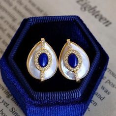 This pair of luxury earring studs have 2 styles: Blue stone and green stone. The vintage-inspired earrings have an oval shape, surrounded with gold lines. The surface is made of mother of pearl, which has a beautiful high luster. Thanks to the silver pin, the earrings are friendly to your skin. Product Specification Pearl-type Shell pearlPearl shape OvalPearl color WhiteStock number 7214Metal Lapis Lazuli ; alloyFor FemaleWeight 5 g Package Includes 1 x Hugetomato earrings1 x Box from HugeTomato Elegant Blue Oval Cabochon Earrings, Elegant Oval Cabochon Earrings For Anniversary, Elegant Oval Cabochon Clip-on Jewelry, Oval Gemstone Gold Plated Earrings, Clip-on Oval Cabochon Earrings For Gifts, Vintage Inspired Earrings, Lapis Lazuli Earrings, Mother Of Pearl Earrings, Luxury Earrings