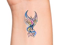 an artistic tattoo design on the side of a woman's leg, with blue and pink swirls