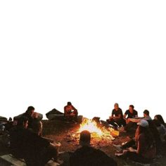 a group of people sitting around a campfire