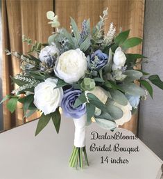 a bridal bouquet with white and blue flowers