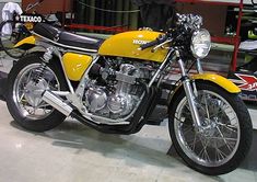 a yellow and black motorcycle parked in a garage