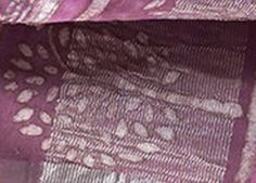 a close up of a purple and white blanket