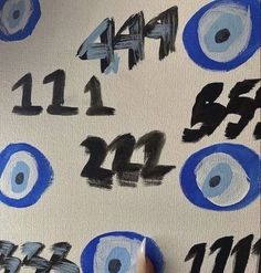 someone is painting numbers with blue and black paint