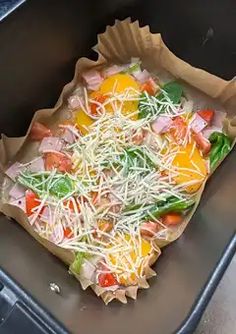 an uncooked pizza sitting on top of a pan covered in cheese and veggies