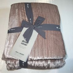 a brown blanket with a tag tied to it