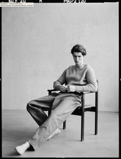 a black and white photo of a person sitting in a chair