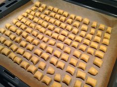 an uncooked pan filled with pastries sitting on top of a stove