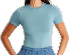 Light Blue Stretch Tops With Solid Color, Basic Seamless Solid Tops, Basic Solid Seamless Tops, Trendy Snug Fit Solid Color Tops, Trendy Snug Fit Solid Top, Trendy Solid Snug Fit Tops, Solid Color Seamless Tops With Relaxed Fit, Seamless Tops With Relaxed Fit, Blue Non-stretch Short Sleeve Top