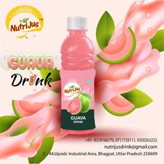 a bottle of guava drink with pink liquid and green leaves on the side, in front of an advertisement for guava drink