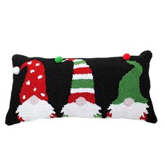 a black pillow with three gnomes on it and one is red, green, white and blue