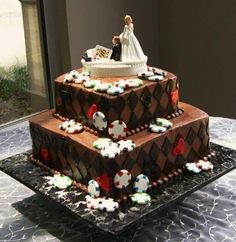 a three tiered wedding cake is decorated with fondant and chocolate icing decorations