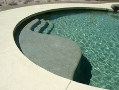 an empty swimming pool with clear blue water