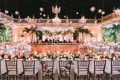 an indoor wedding venue with chandeliers and tables set up for a formal function