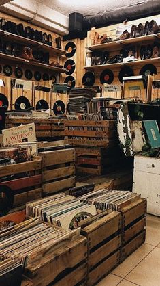 a room filled with lots of wooden boxes and records