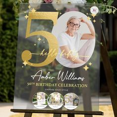 a 50th birthday party sign with flowers and greenery