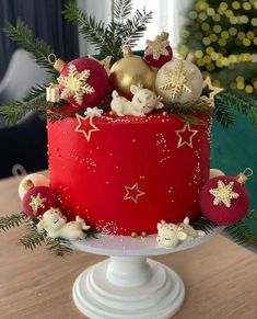 a red christmas cake with ornaments on top