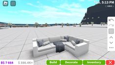 a virtual view of a living room with couches and pillows on the floor, in front of a blue sky