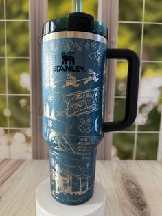 a blue travel mug sitting on top of a table