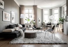 a living room filled with furniture and lots of windows