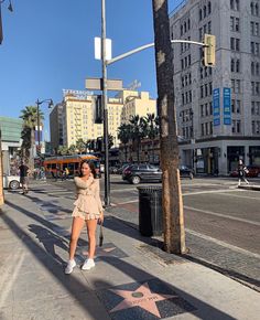 a woman taking a selfie on the hollywood walk of fame