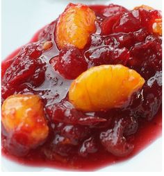 cranberry sauce with oranges and cherries on a white plate, ready to be eaten