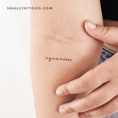 a woman's arm with the word agonars tattooed on her left side