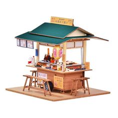 a small wooden kiosk with food and drinks on it's roof for sale