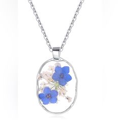 a blue and white flower in a circle pendant on a silver plated necklace chain