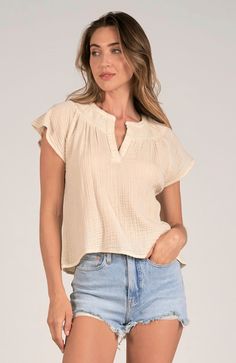 Introducing our luxurious Cream Gauze Shirt. Made from high-quality gauze fabric, this shirt is the perfect blend of comfort and elegance. Its cream color adds a touch of sophistication to any look. Upgrade your wardrobe with this versatile piece today! Measurements: The model is wearing a size small. Fit: This piece is true to size for a comfortable and flattering fit. Care Instructions: Machine wash cold on a gentle cycle with like colors. Avoid bleach. Hang dry to maintain shape and prevent s Beige V-neck Blouse For Layering, Classic Neutral Cotton Blouse, Classic Cotton Blouse In Neutral Color, Chic Cream Top For Layering, Chic Cream Tops For Layering, Beige Relaxed Fit Blouse For Layering, Beige Feminine Blouse For Layering, Feminine Cotton Blouse For Layering, Classic Neutral Tops For Layering