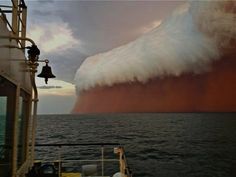 a large wave is coming in to the ocean from a ship's deck as it passes by