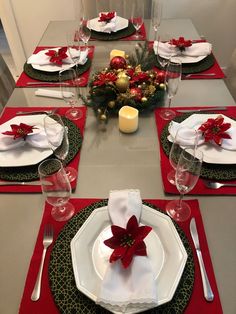 the table is set with red and green place settings