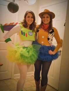 two women dressed in costumes standing next to each other