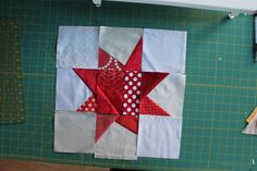 the quilts are laid out on the cutting board to make a star shaped wall hanging