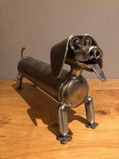 a metal dog sitting on top of a wooden table