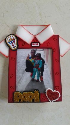 an image of two children in front of a red frame