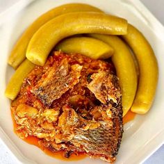 a white plate topped with fish and pickles