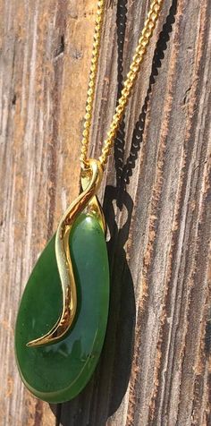 Beautiful teardrop shape jade pendant in gold-tone setting. The genuine Canadian nephrite jade stone measures 27mm long. Add it to your favorite gold chain for a stunning look! A Grade Canadian Nephrite Jade All of our Jade is 100% natural. 30 day satisfaction guarantee! Jade is a natural stone, so the shade of color may vary slightly. All of our jade is grade A, unless otherwise noted. It is 100% Pure Nephrite Jade, with no treatments whatsoever. What is Jade? Jade is one of two gemstones, neph Gold Teardrop Jade Jewelry, Chinese Jade, Nephrite Jade, Teardrop Pendant, Jade Jewelry, Magnetic Bracelet, Natural Jade, Jade Stone, Jade Pendant