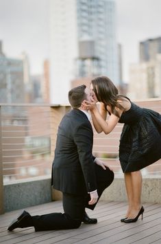 a man kneeling down to kiss a woman's face