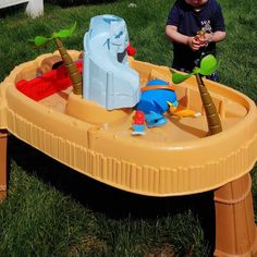 a little boy playing with an inflatable toy boat