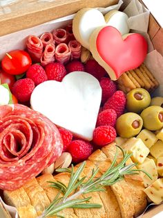 a box filled with lots of different types of food and meats on top of each other