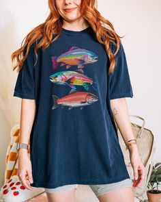 North American Fish Comfort Colors Shirt, Retro Lake Fish Tee Fishing Tshirt For Fish Lover Gift, Rainbow Trout Unisex Graphic Tshirt Nature Comfort Colors C1717 Shirts - Shirt sizes are unisex, please refer to sizing chart in listing photos - 100% ring-spun cotton - Color blast effect will vary on every shirt. We cannot guarantee consistency among individual shirts. The Models in the pictures are wearing 1 or 2 sizes up, Please order 1 or 2 sizes up for an oversized look from their normal women's size or select your normal women's size for a little extra room and to tie it. WOMEN'S SHIRTS - Women usually wear their normal women's size. CARE Machine wash warm (not exceeding 105 F) inside out Tumble dry medium Do not iron on the print! RETURN/EXCHANGE POLICY All items are made to order and Oversized Tshirt Outfit Women, Fish Clothes, Rad Outfits, Lake Fish, Oversize Tshirt Outfits, Fish Shirt, Gift Inspo, Rainbow Trout, Comfort Colors Shirt