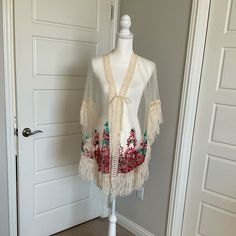 Tie-Front Cream Colored Cover Up With Beautiful Red, Pink And Green Floral Embroidery And Fringe Sleeves One Size Brand New / Never Worn With Tags Embroidered Long Sleeve Cover-up For Vacation, Bohemian Floral Embroidered Cover-up For Spring, Embroidered Cover-up For Spring Vacation, Embroidered Spring Cover-up For Vacation, Spring Vacation Embroidered Cover-up, Embroidered Spring Vacation Cover-up, Spring Festival Embroidered Cover-up, Embroidered V-neck Cover-up, Bohemian Style Cover-up For Spring Holiday