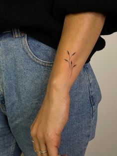 a woman with a small tattoo on her arm