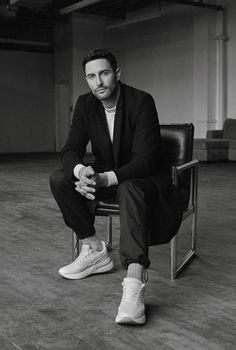 a man sitting on top of a chair in a room