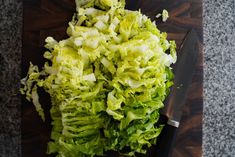 chopped lettuce on a cutting board with a knife