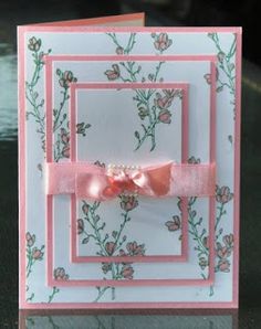 a pink and white card with a bow on it