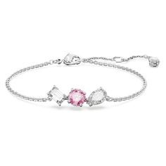 Accented with a vibrant flourish of color, this Mesmera bracelet is ready to impress. The rhodium plated design is worn on a delicate chain with a hanging elongation and features a trio of prong-set Swarovski Zirconia in varying shapes, including a central round stone in blush pink. A bold mix of cuts that would make a wondrous gift. Pink And Silver Jewelry, Bracelets Expensive, Swarovski Jewelry Aesthetic, Swarovski Jewelry Bracelet, Silver Friendship Bracelets, Pink Crystal Bracelet, Bracelet Packaging, Pink Swarovski, Swarovski Bracelet