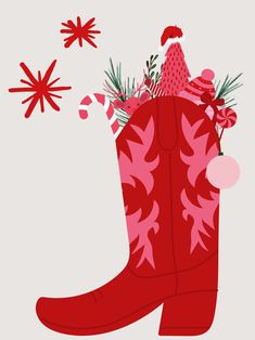 a red cowboy boot with christmas decorations on the inside, and snowflakes in the background