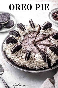 an oreo pie on a plate with oreos around it and the cake is ready to be eaten